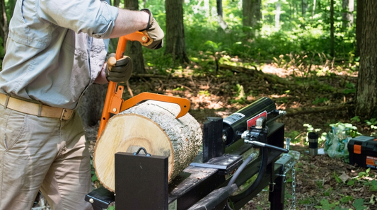 Man using LogOX 3-in-1 Forestry MultiTool cant hook to roll a heavy log round onto a hydraulic splitter in the forest